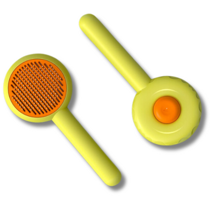 Yellow and orange cat brush for removing loose fur and massaging, ergonomic design for comfortable grooming.